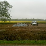 Against the backdrop of the blooming fields of rapeseed, the concrete base for the Memorial is being built.